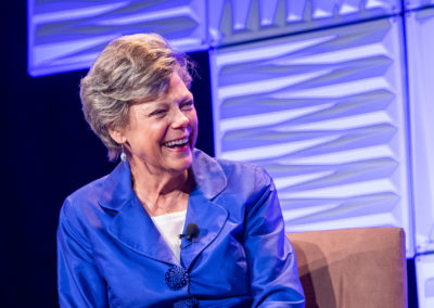 Award winning journalist Cokie-Roberts seated in a blue dress and smiling at the 2018 Bridges Gala