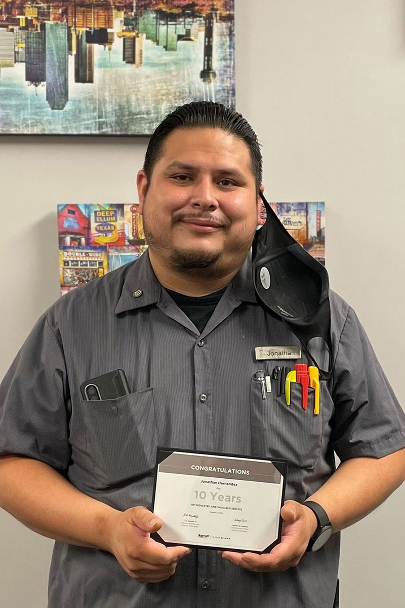 Jonathan Hernandez, a Dallas - Ft. Worth participant, holding with his 10-year anniversary award.