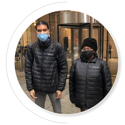 Two African American young people in winter coats standing in front of the entrance to JPMorgan Chase in Chicago