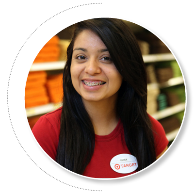 Smiling young Latina woman with dark hair in red dress working in a Target store